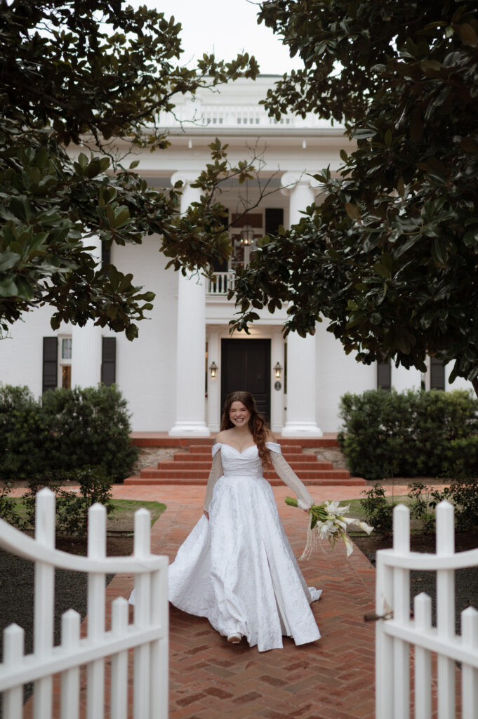 bride walking in front of Woodbine Mansion