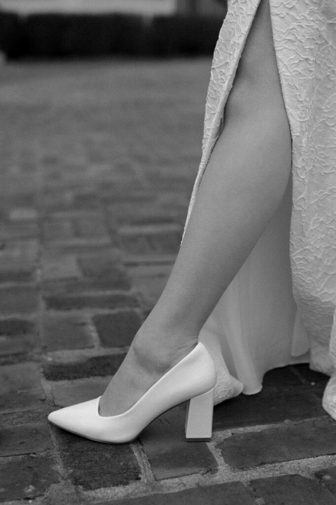 editorial photo of bride's leg and wedding shoe