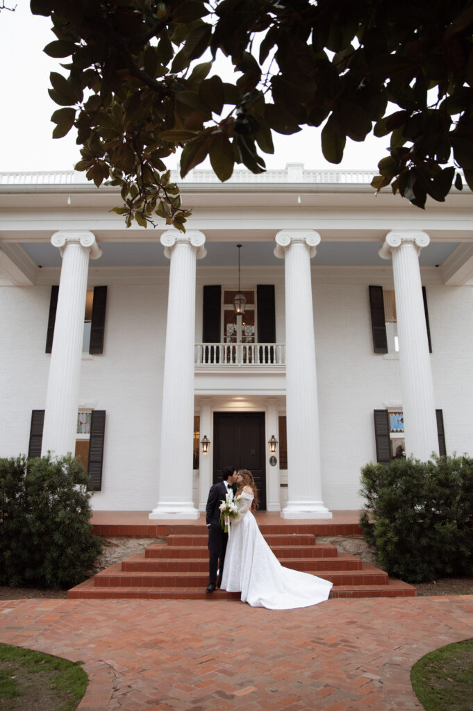 bride and groom kissing at their Austin wedding venue