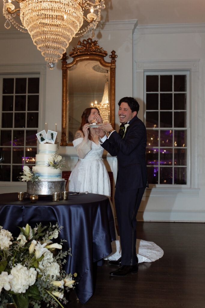 bride and groom eating cake at Woodbine Mansion wedding
