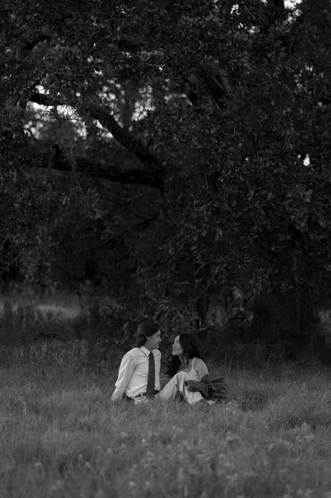 couple flirting under a tree in Dallas, TX