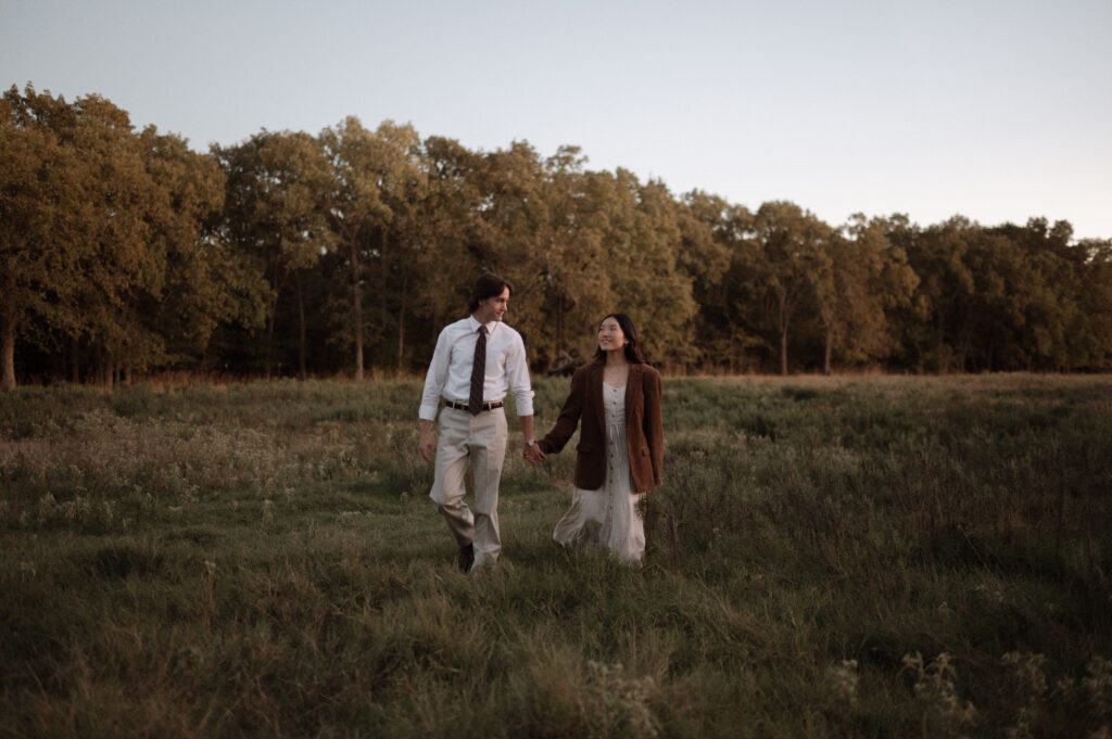 couple walking through a big field together