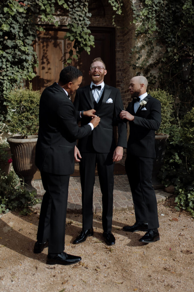 groom laughing with groomsmen