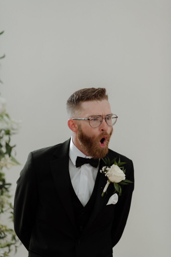 Groom seeing bride walking down the aisle
