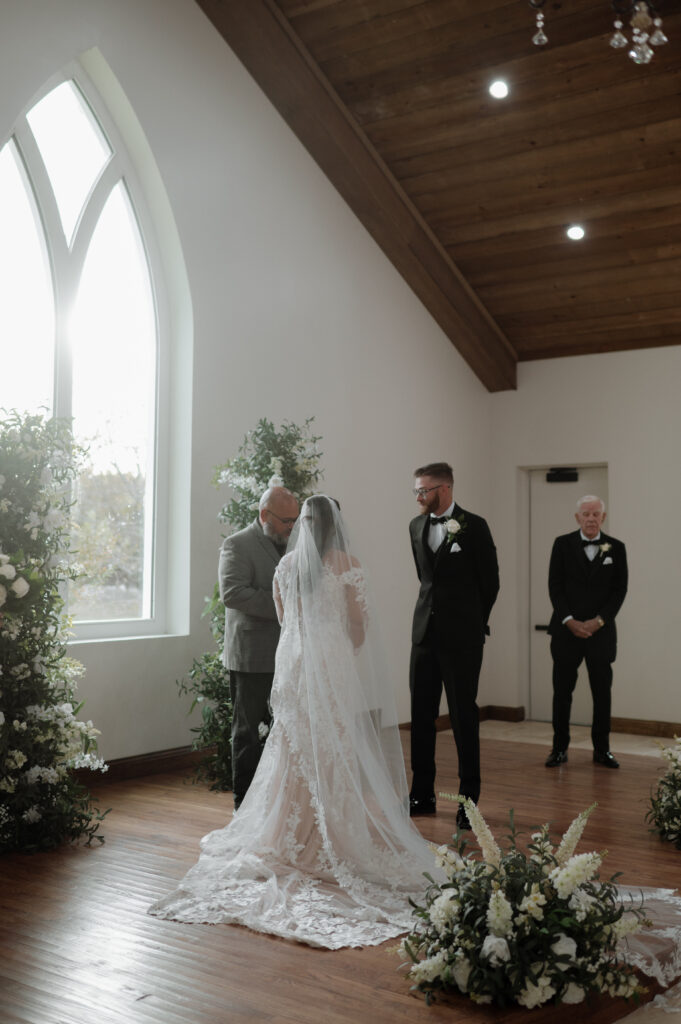bride and groom during ceremony in a chapel