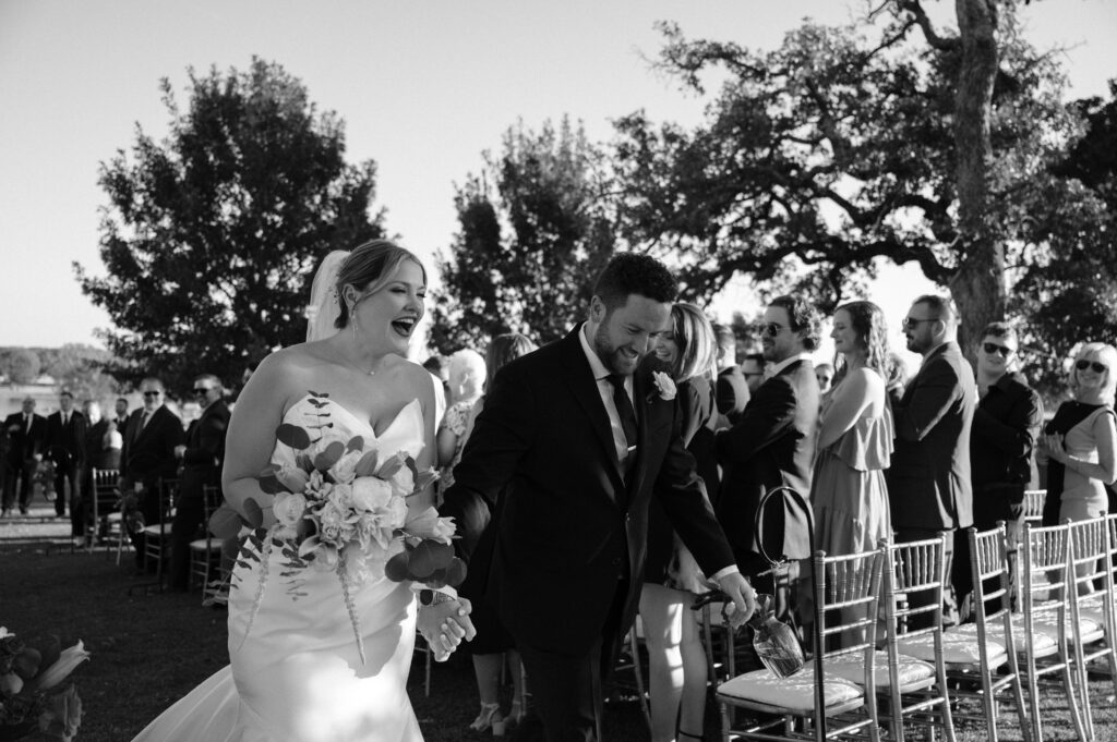 bride and groom walking down the aisle after getting married