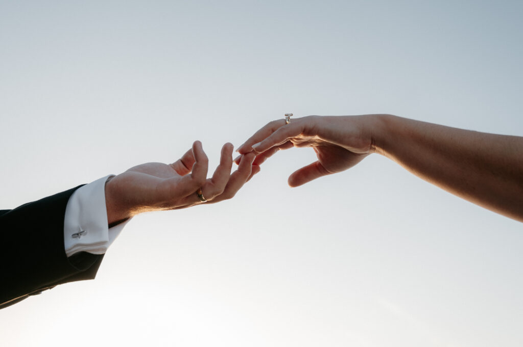 bride and groom closeup photo of hands and rings taken by Dallas Wedding Photographer