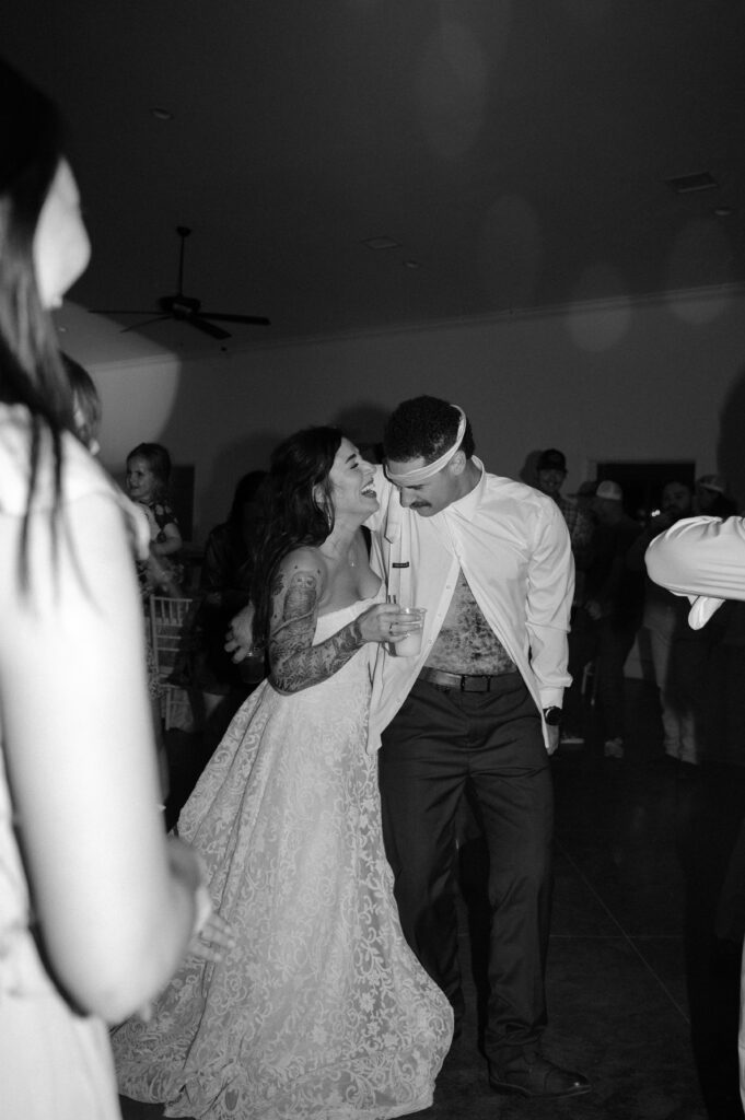bride and groom having fun at their wedding reception