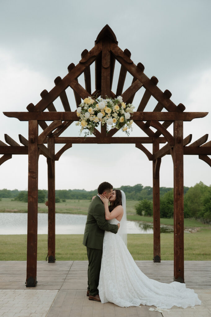 bride and groom first kiss as husband and wife taken by Dallas Wedding Photographer