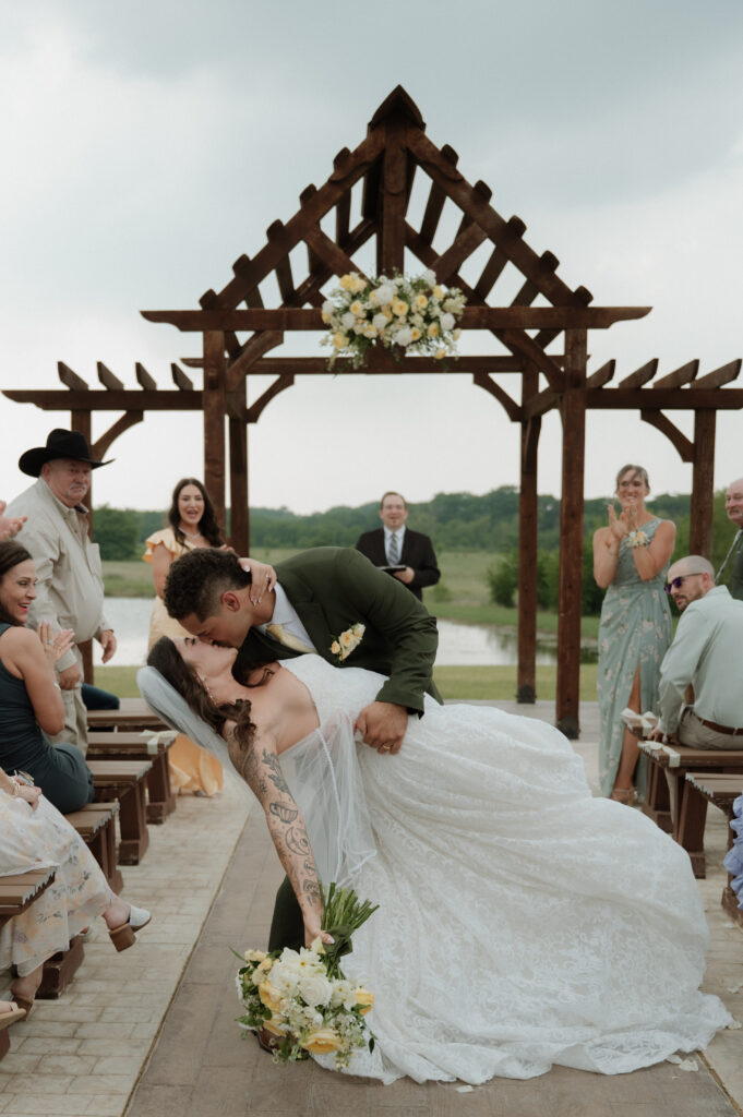 bride and groom kiss during recessional