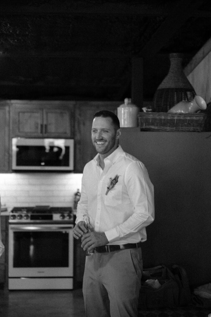 candid photo of groom getting ready