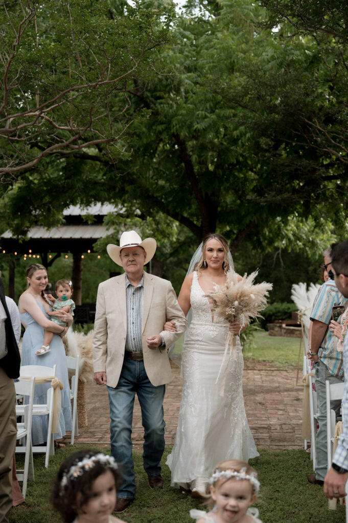 photo of bride walking down the aisle with her father taken by Dallas Wedding Photographer