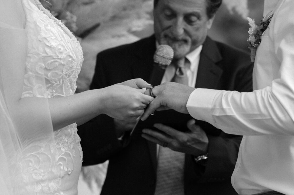 photo of bride and groom exchanging rings