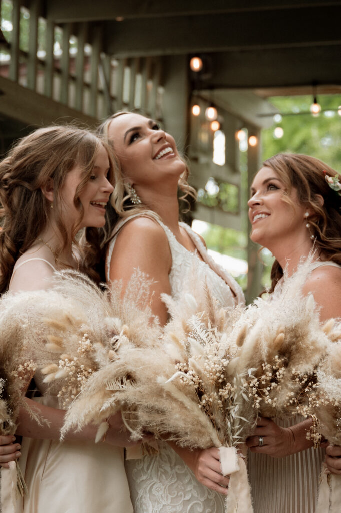 photo of bride laughing with her bridesmaids taken by Nicole Endress Photography