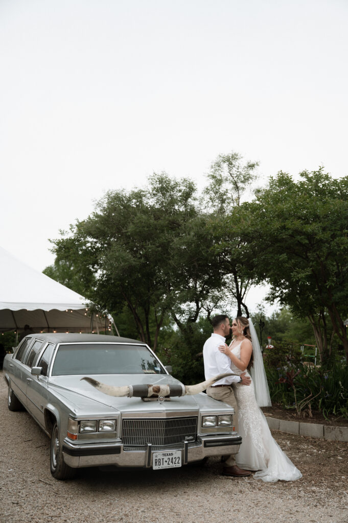 photo of bride and groom with Texas Longhorn Car