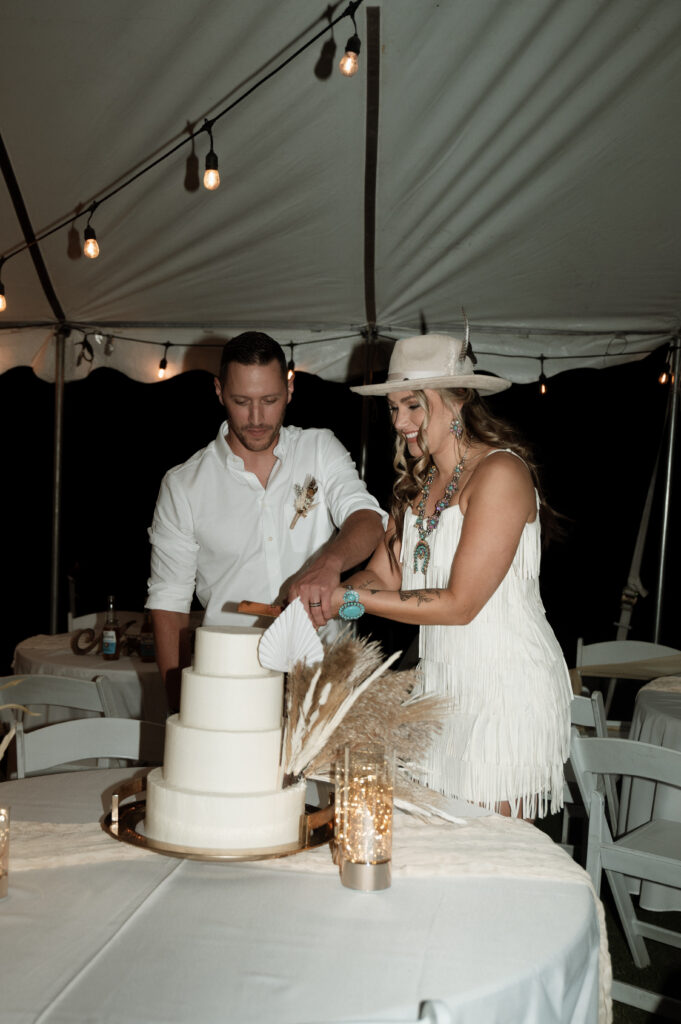 bride and groom cutting their boho chic cake