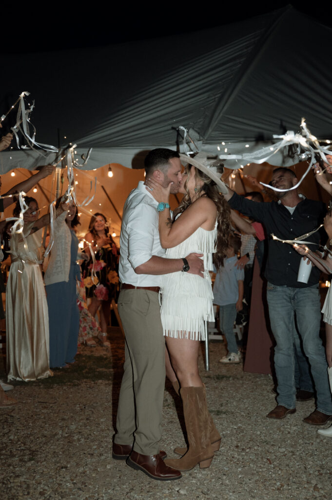 bride and groom grand exit with twinkle lights