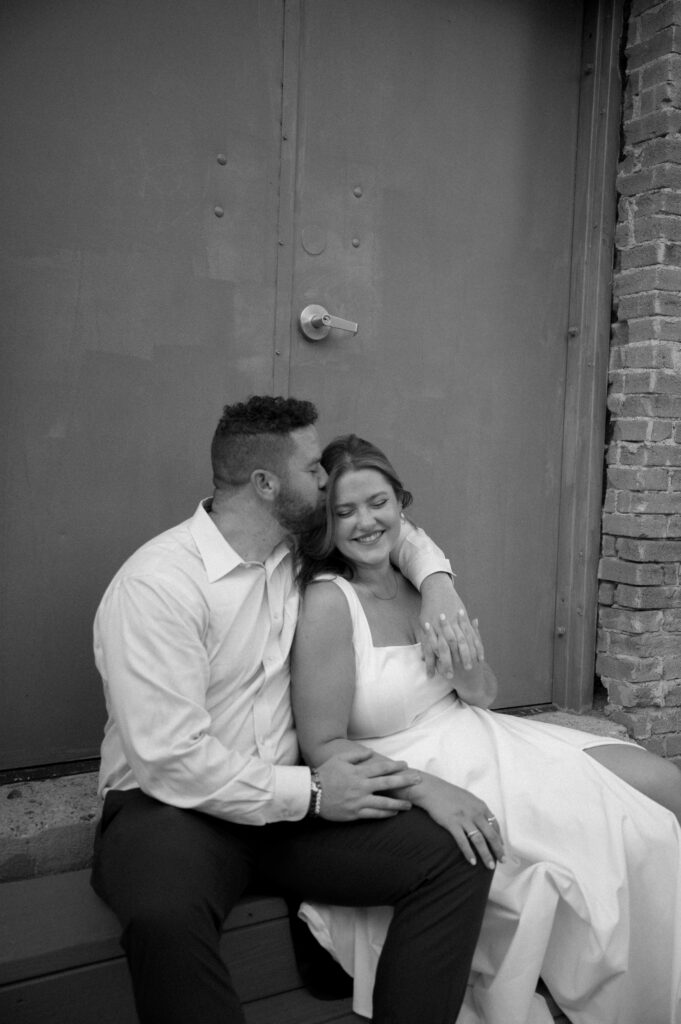 photo of couple snuggling together in the Bishop Arts District taken by Dallas Wedding Photographer