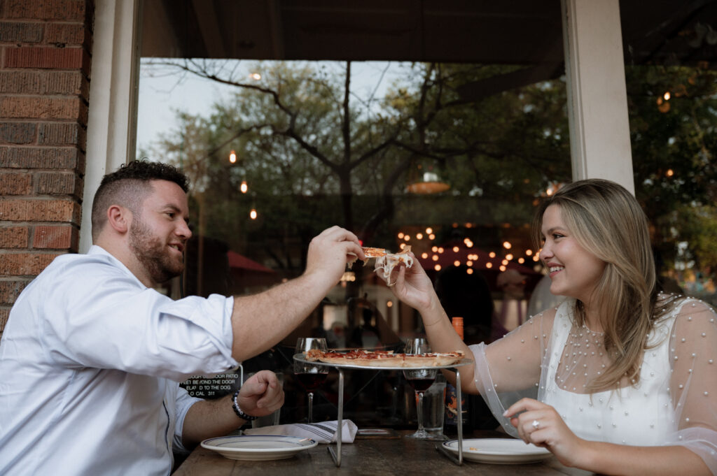 couple eating pizza at Eno's Pizza Tavern in Dallas, TX