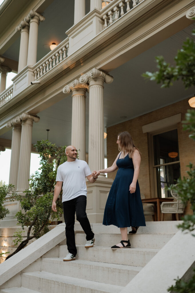 engaged couple walking down the steps at Hotel Ella taken by Austin Wedding Photographer