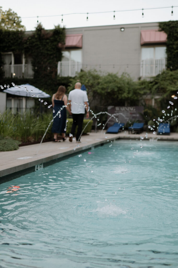 engagement photo taken at the pool at Hotel Ella