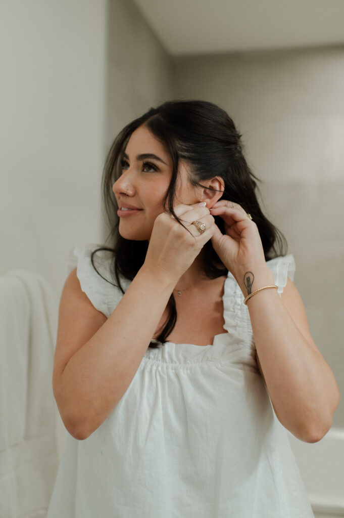 photo of bride putting her earrings in taken by Breckenridge Wedding Photographer