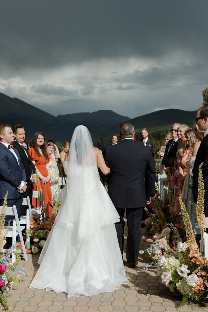 bride walking down the aisle in the mountains
