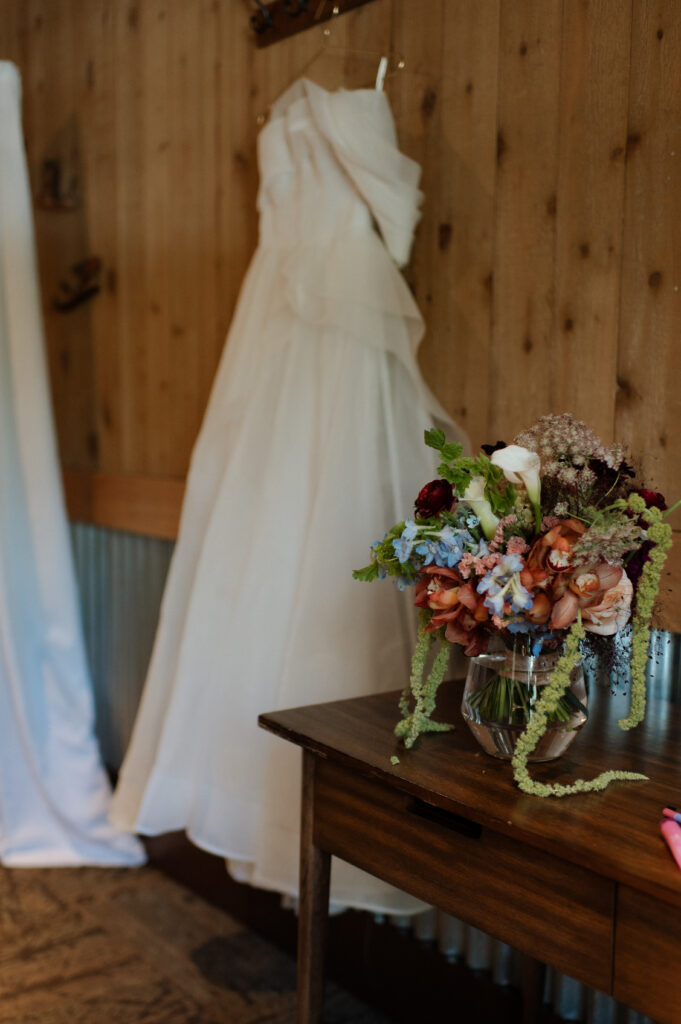 photo of wedding bouquet and wedding dress taken by Nicole Endress Photography