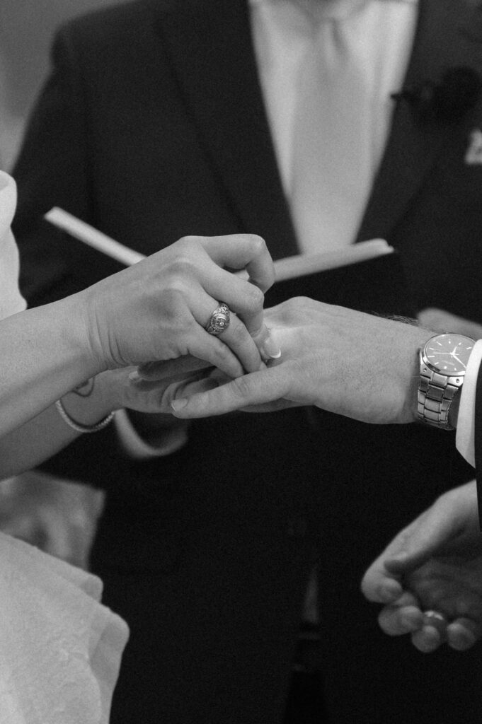 bride and groom exchanging rings during mountain wedding ceremony