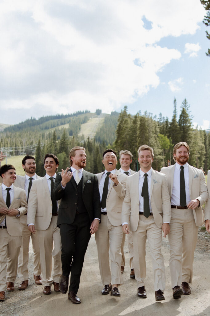 groom and groomsmen walking at TenMile Station, a Breckenridge wedding venue