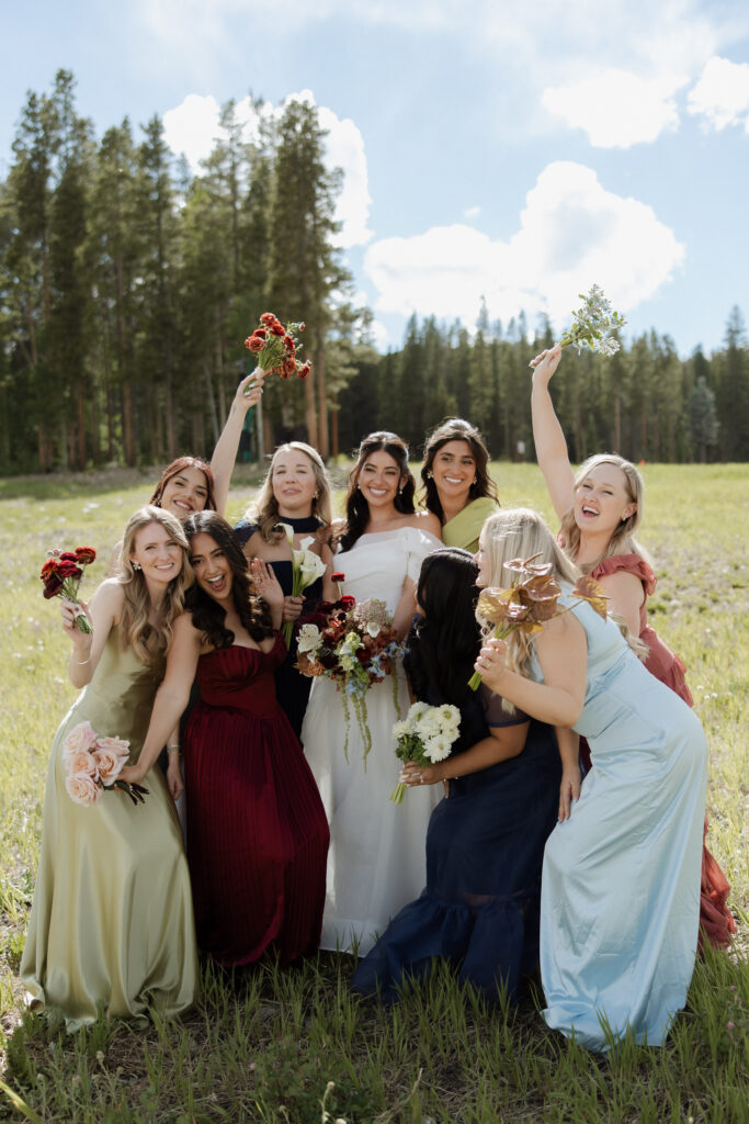 bride and bridesmaids laughing together in the mountains taken by Nicole Endress Photography