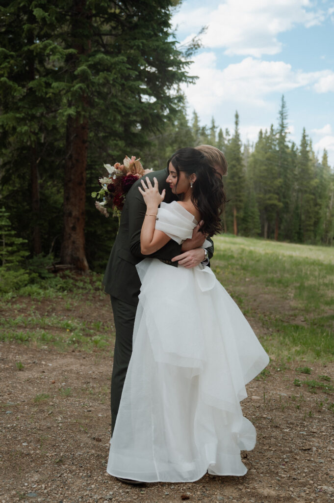 bride and groom embracing outside at TenMile Station, a Colorado wedding venue