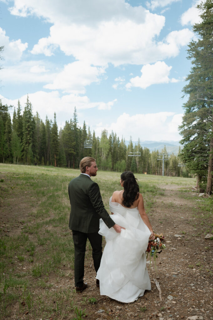 photo of bride and groom walking in the moutains