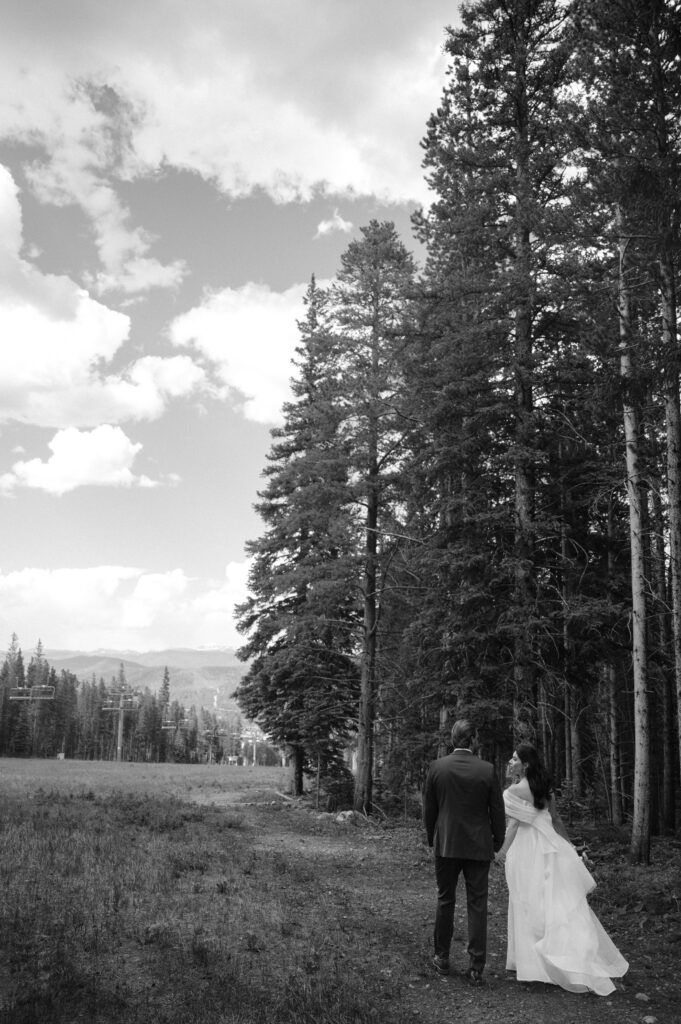 black and white photo of bride and groom in the mountains