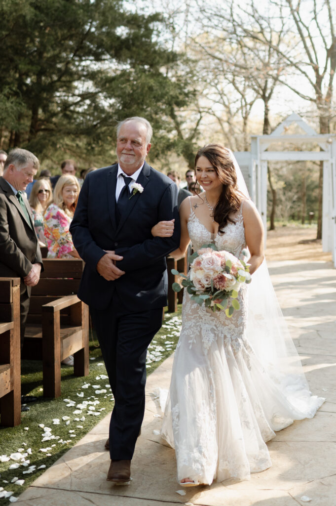 bride walking down the aisle with her dad taken by Texas Wedding Photographer
