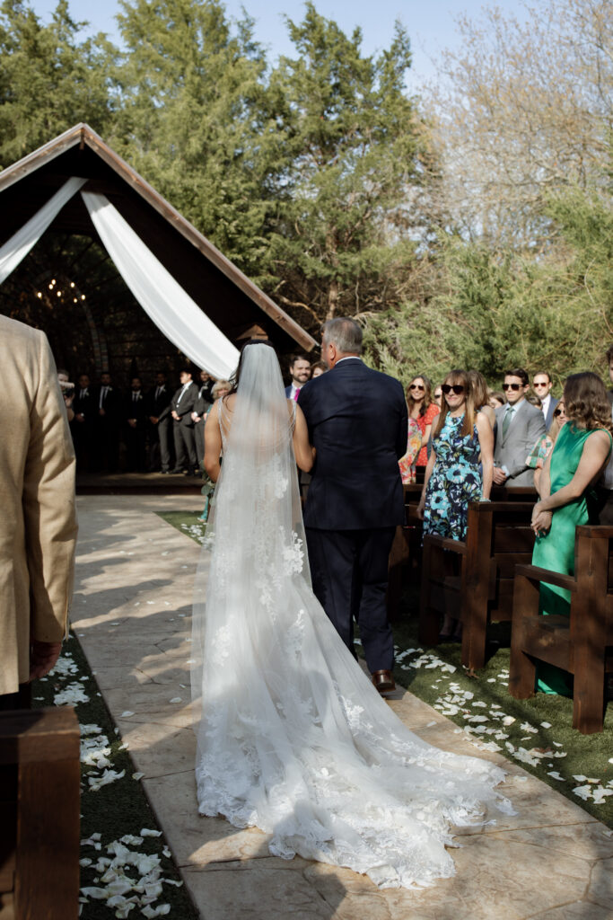 bride walking down the aisle at Avalon Legacy Ranch