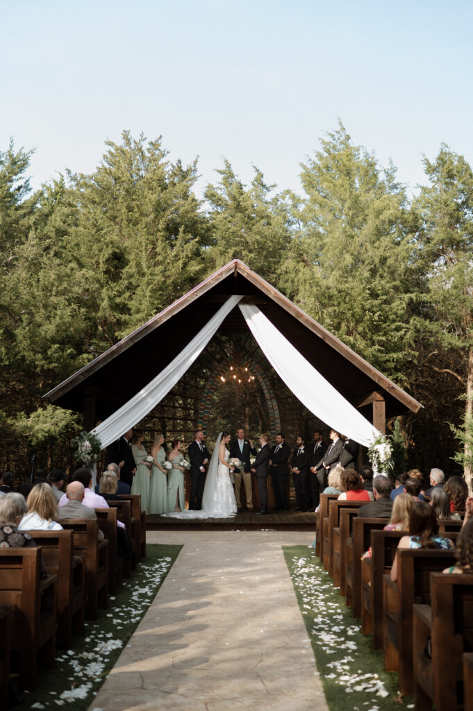 bride and groom exchanging vows during wedding ceremony taken by Dallas Wedding Photographer