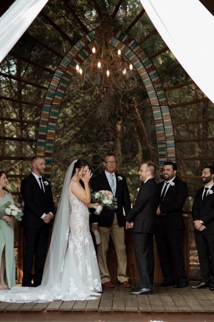 photo of bride laughing during wedding ceremony at Avalon Legacy Ranch taken by Dallas Wedding Photographer