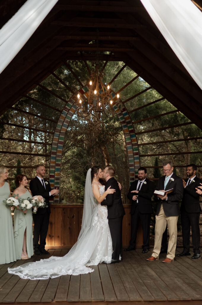 photo of bride and groom first kiss at Avalon Legacy Ranch wedding venue
