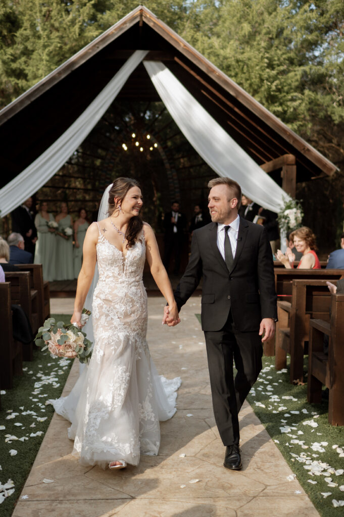 bride and groom walking down the aisle after saying I Do!