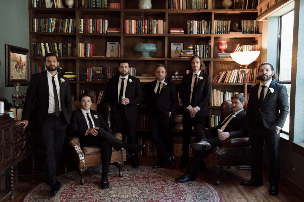 Groom and groomsmen in the library at Avalon Legacy Ranch