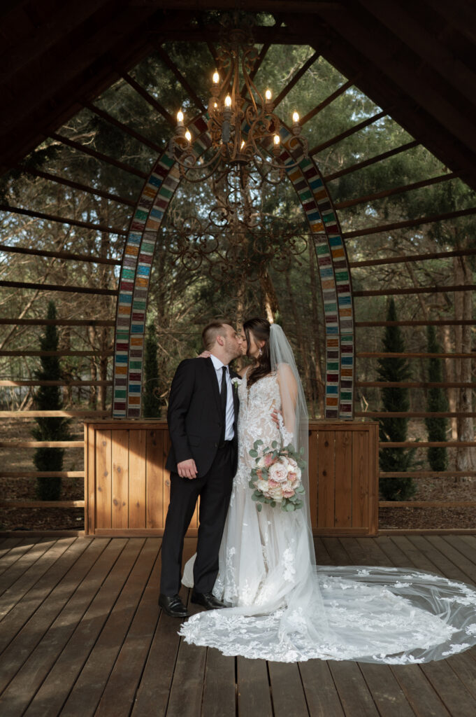 photo of bride and groom kissing at Dallas wedding venue taken by Texas Wedding Photographer