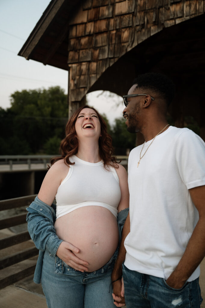 couple laughing during maternity photos
