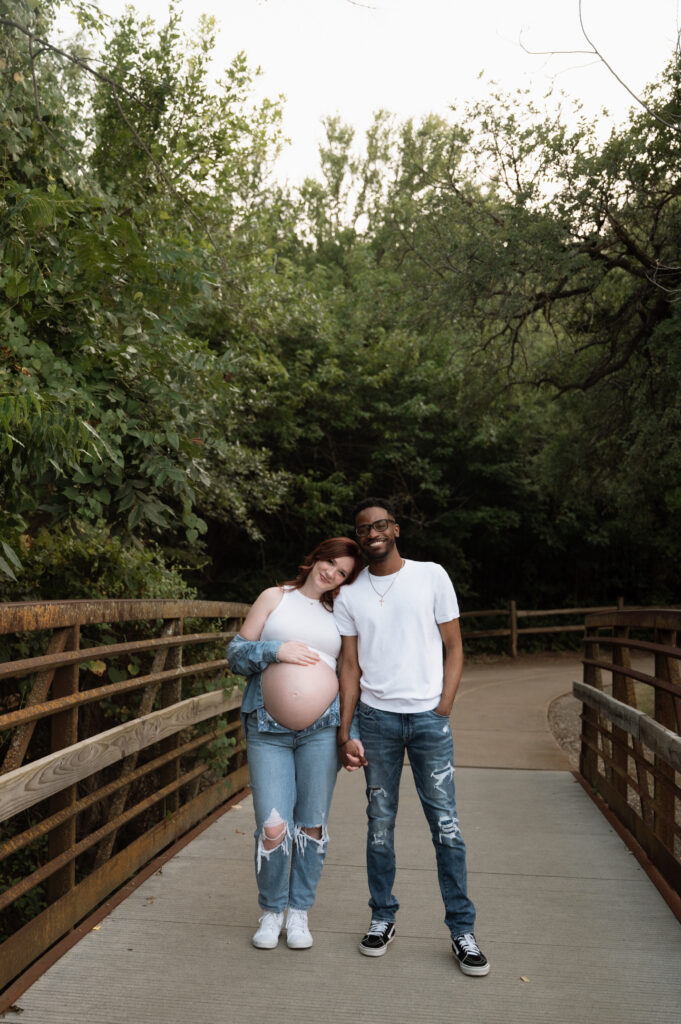 couple maternity photos taken at a park in Keller, TX by Nicole Endress Photography