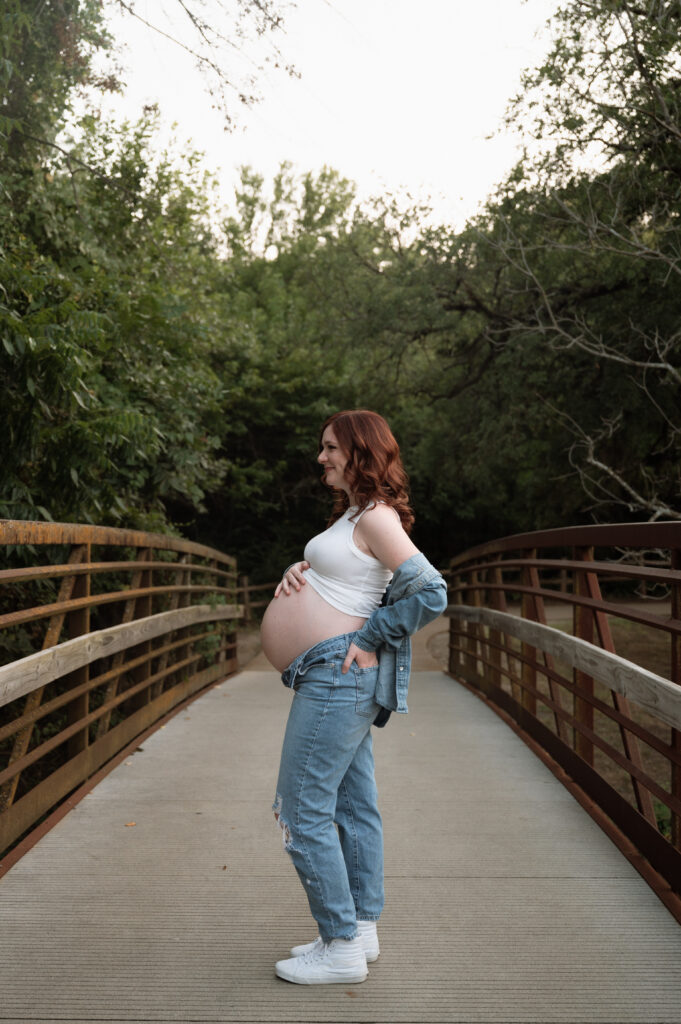 side view photo of pregnant mom in denim