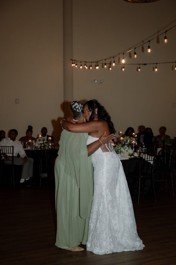 bride and mother dancing at wedding reception