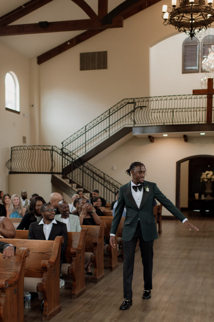 photo of groom walking down the aisle, excited to get married taken by Dallas Wedding Photographer