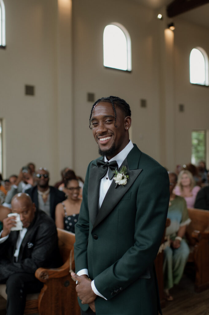 photo of groom during ceremony in his custom tux taken by Dallas Wedding Photographer