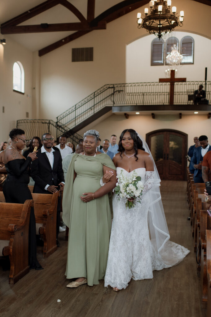 bride and her mother walking down the aisle