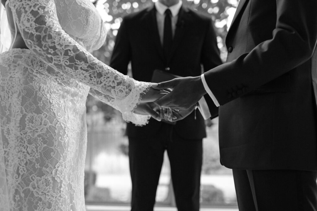 bride and groom holding hands during wedding ceremony at Chapel at Ana Villa